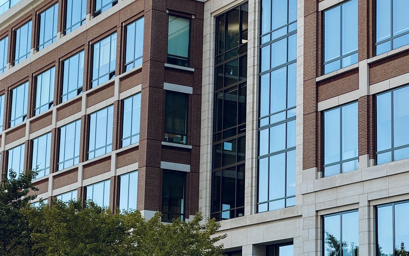 A modern multi-story commercial building with a brick and glass facade