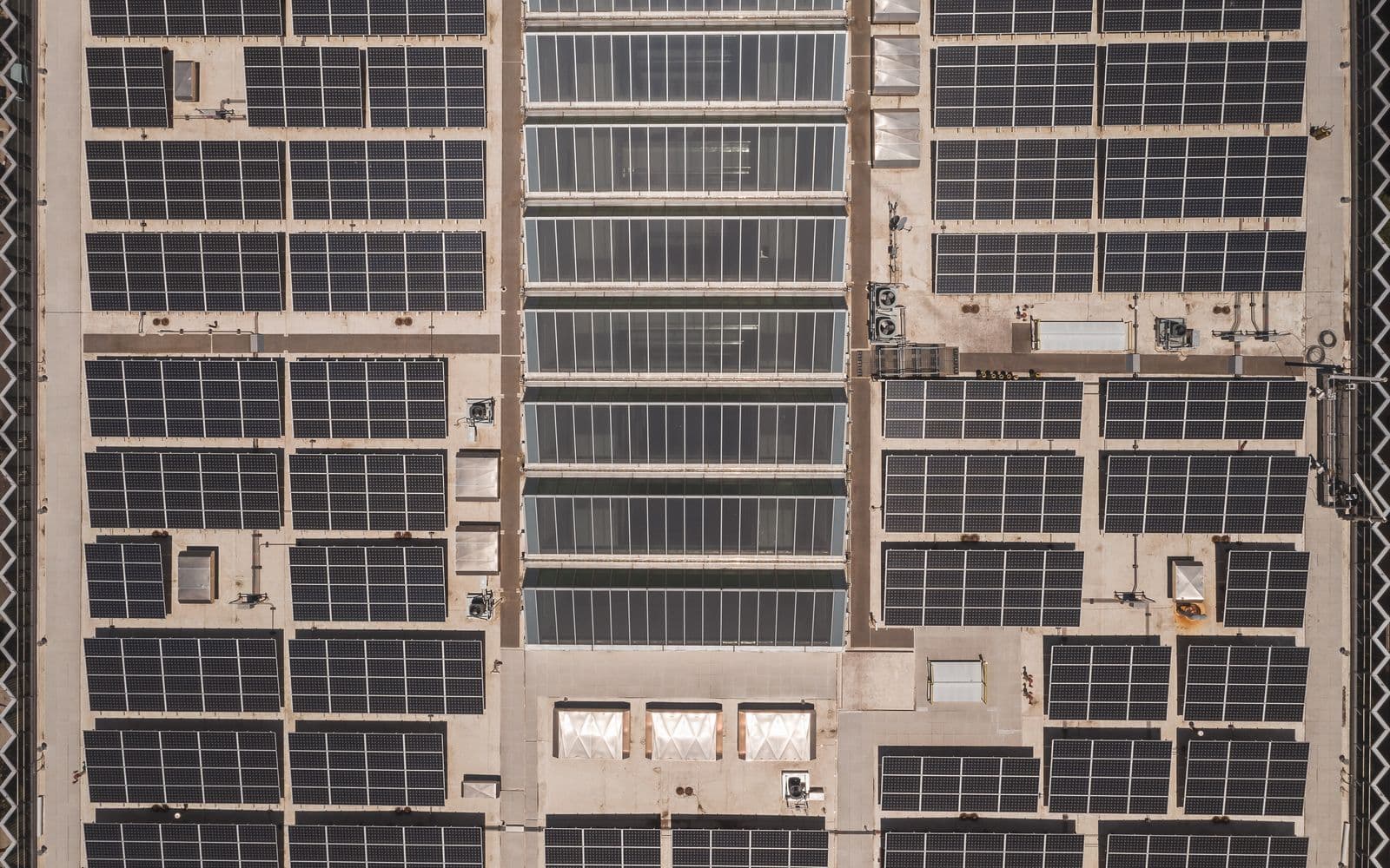 Aerial view of a large rooftop solar panel array